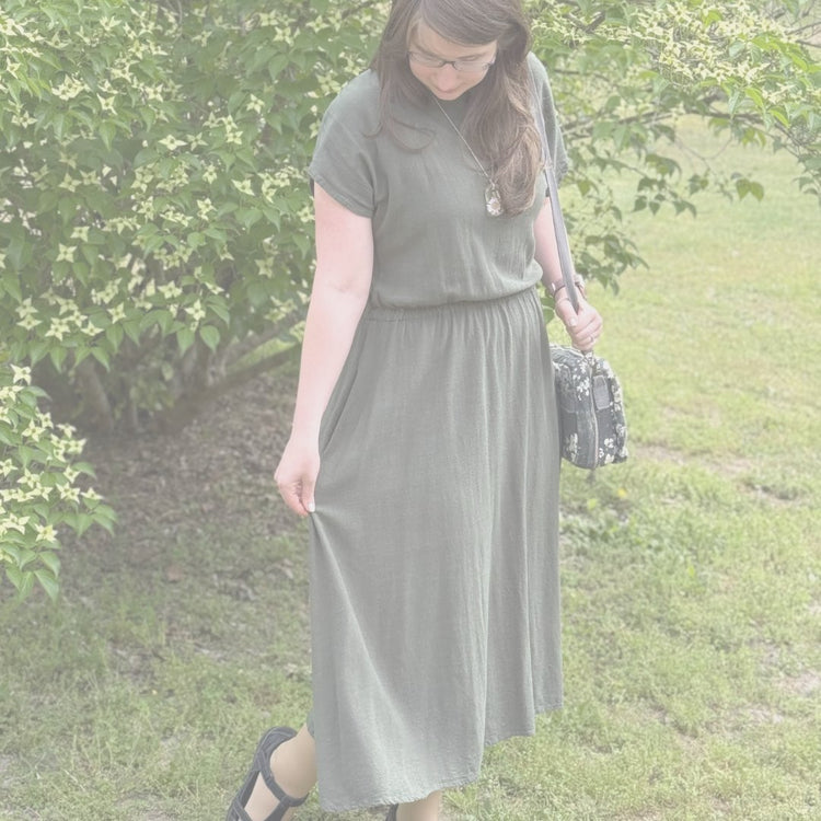 Woman modeling custom sewn smocked denim dress and tote bag