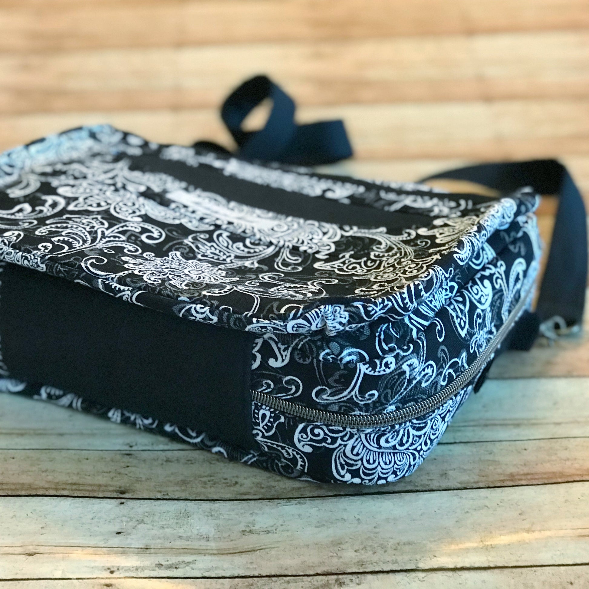 bottom flat lay view of bible bag with antique brass zipper, sewn from a black charcoal gray and white print