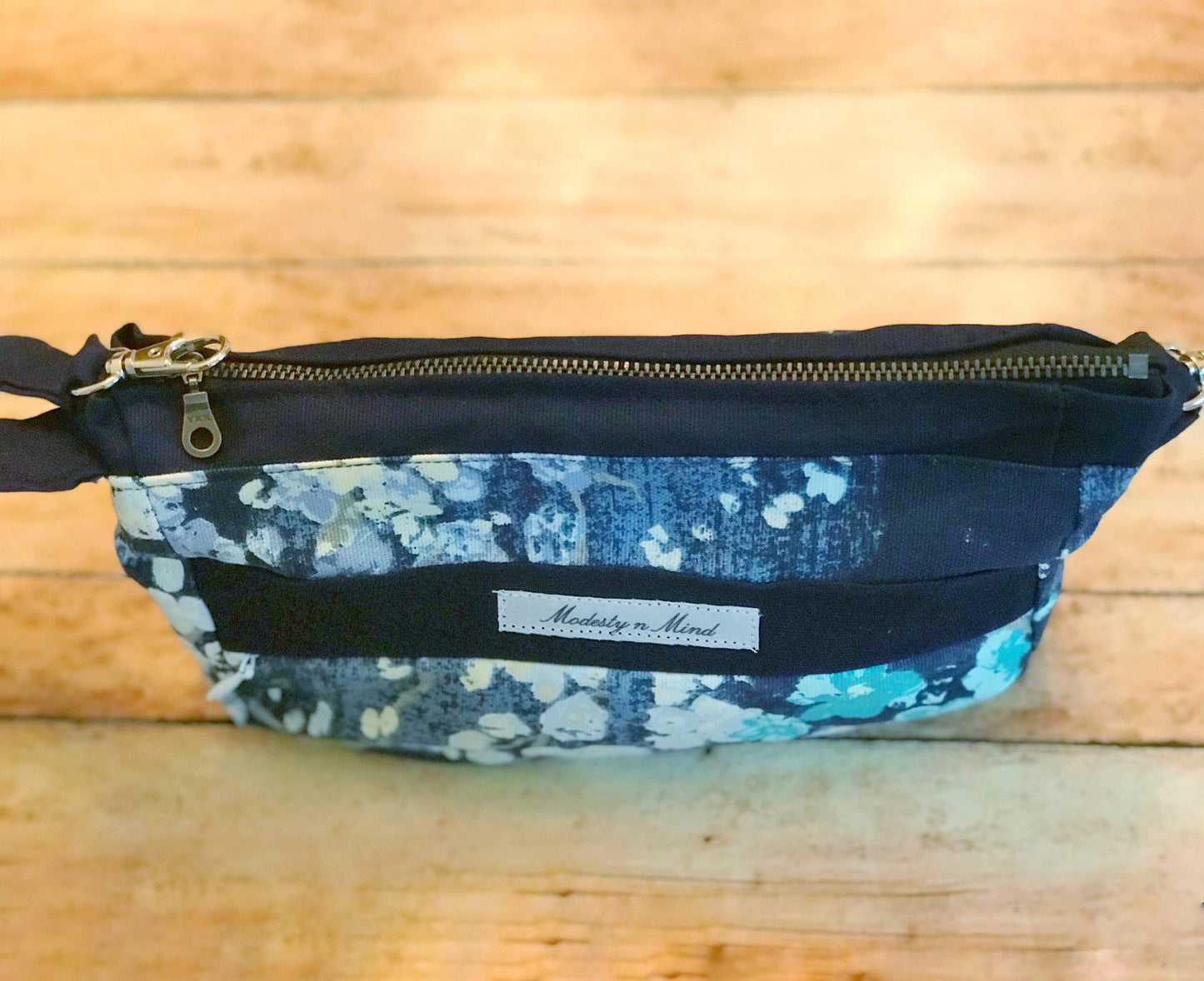 top view of blue teal floral wristlet and of metal zipper used