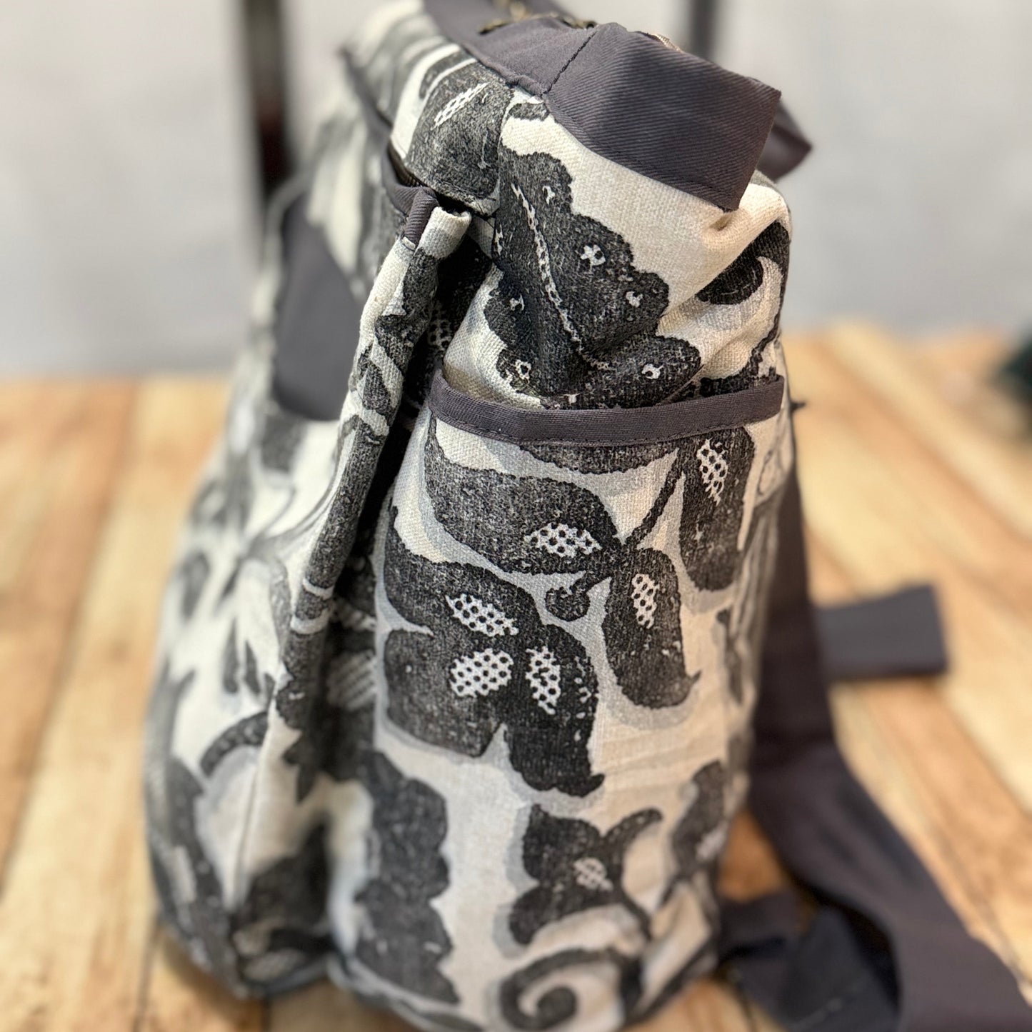 Patterned bag on a wooden surface with a blurred background