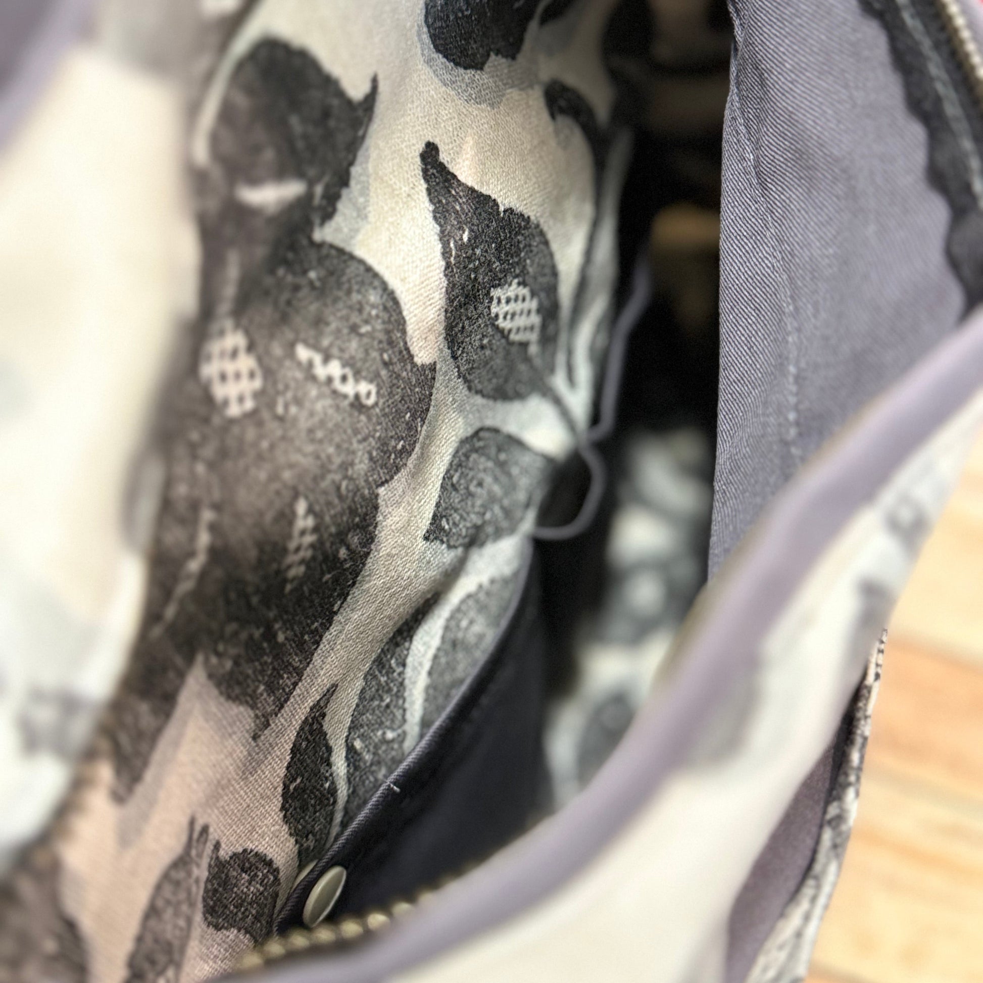 Close-up of a pocket in a bag made from a patterned fabric.