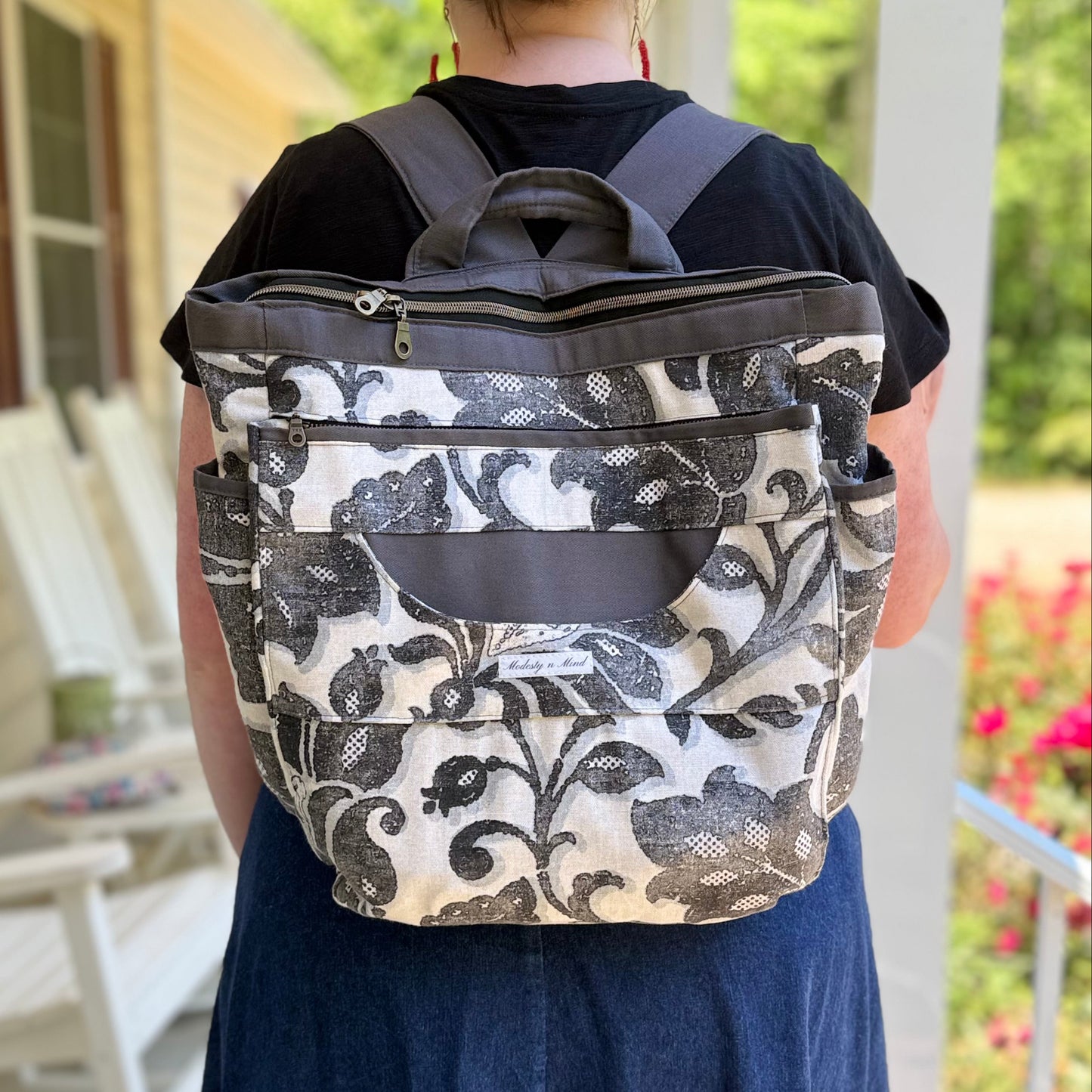 Person wearing a floral-patterned backpack outdoors