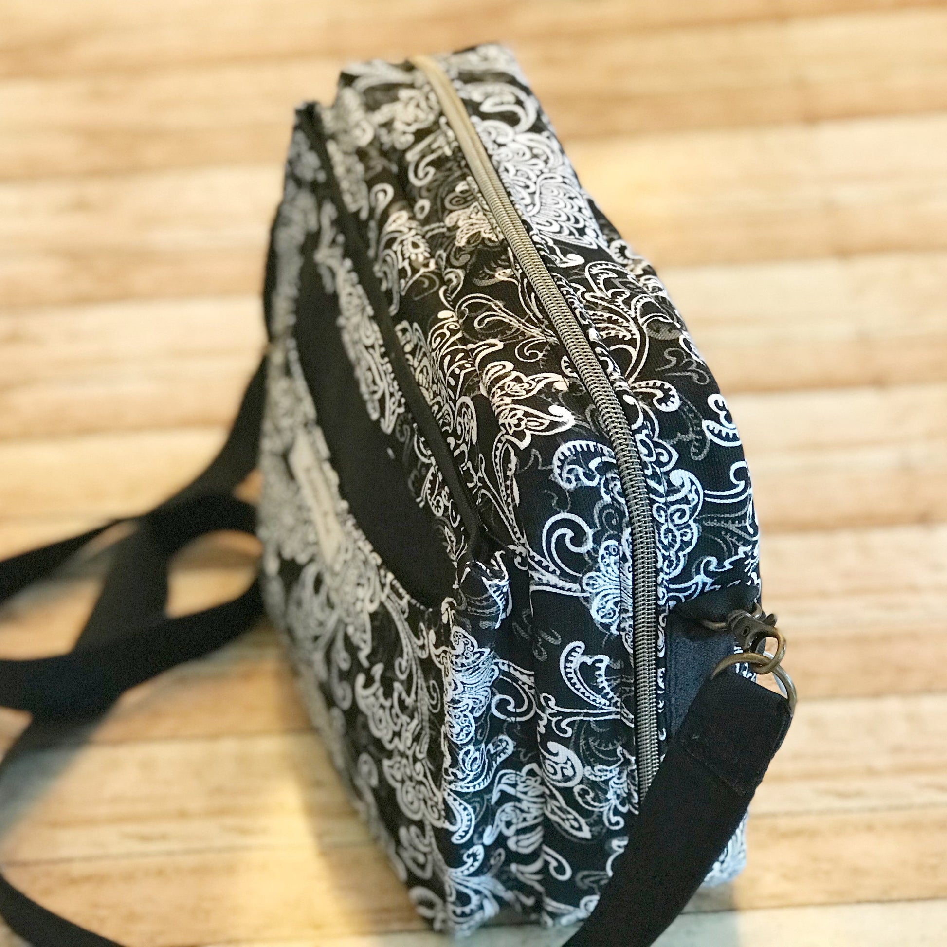 top side view of black white and charcoal printed Bible Bag with Antique brass zipper & purse hooks.