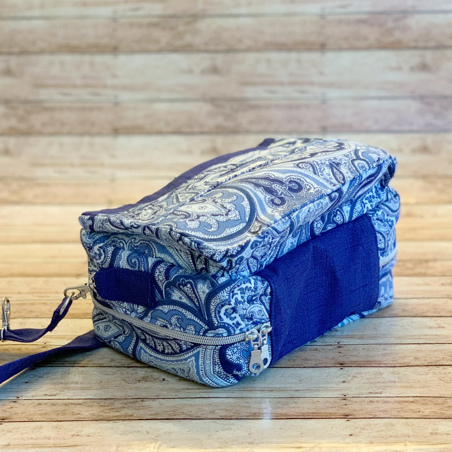 Bottom/side view of multi colored blue Bible Bag with silver two-way zipper
