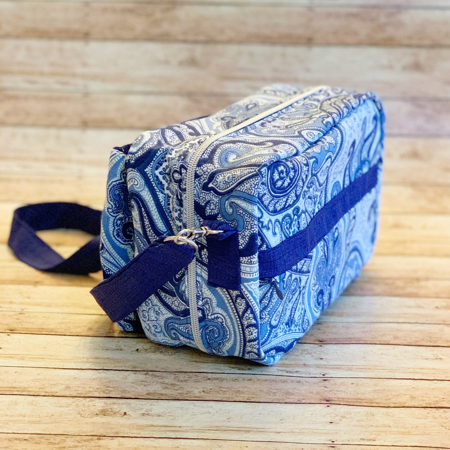 Back/side view of multi-colored blue paisley Bible Bag. Shows back invisible zipper pocket & purse hook with strap